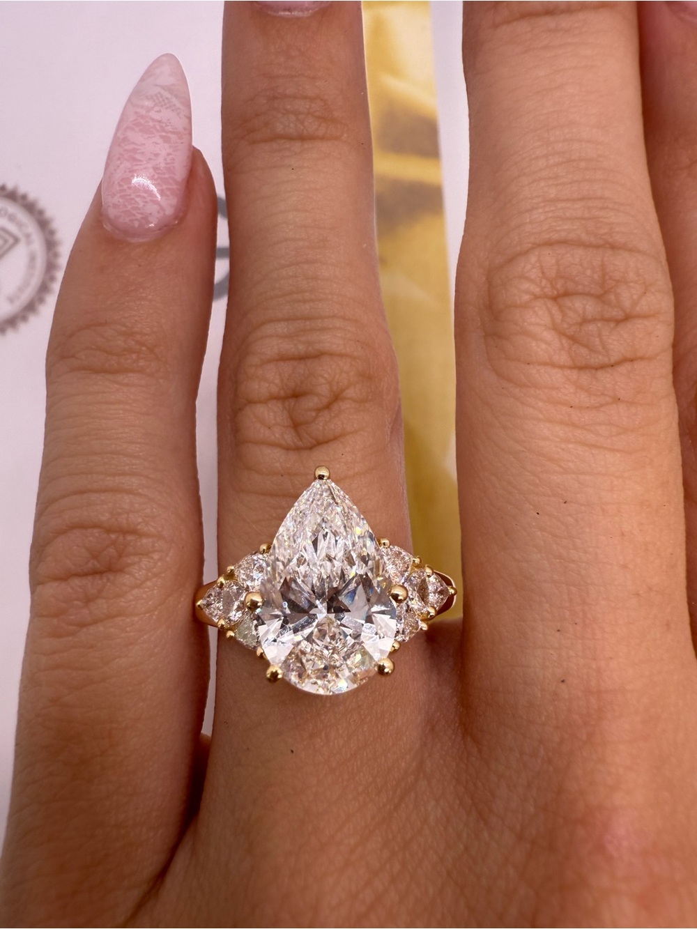 4.04 carat E VS1 pear diamond with trillion side diamonds engagement ring